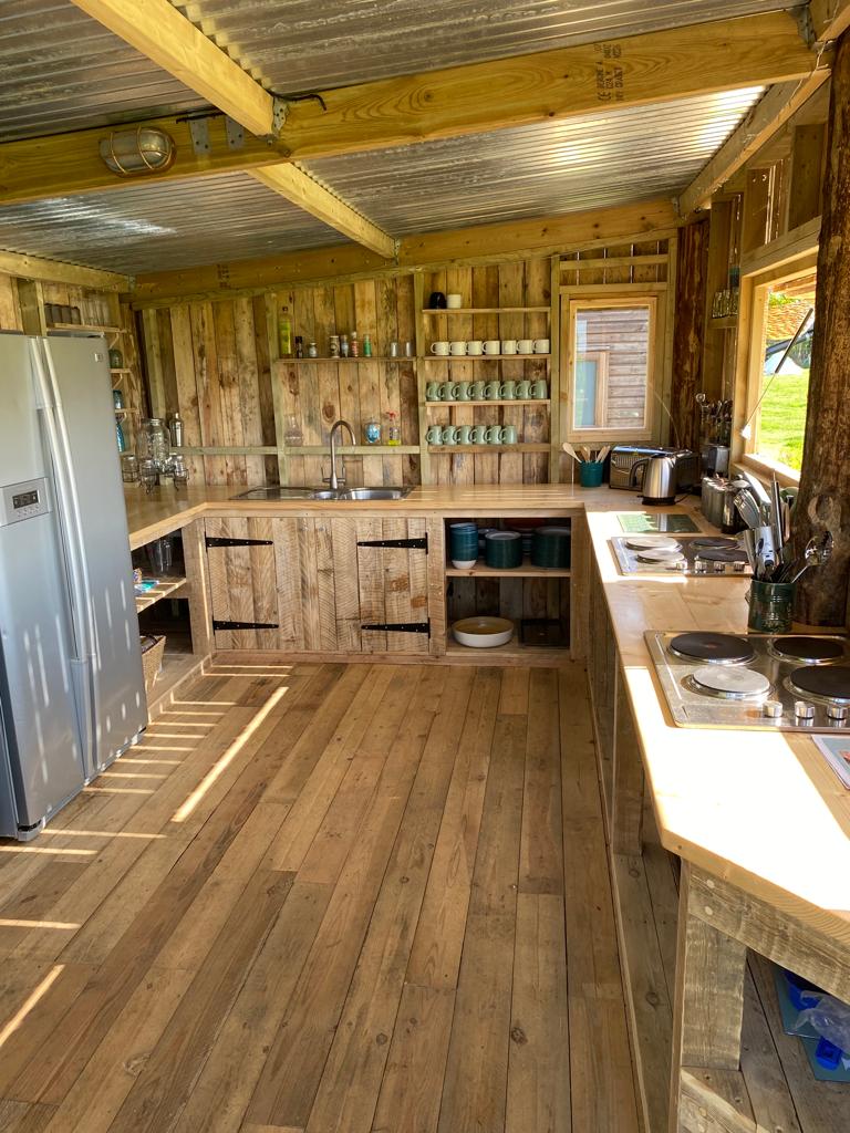 Rustic communal kitchen made of reclaimed timber